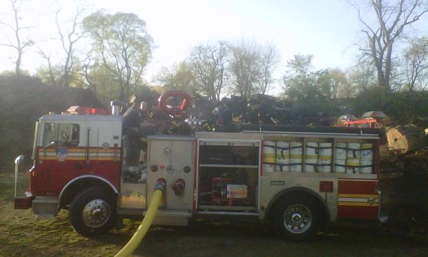 A firetruck in front of the smoldering remains of the fire in Central Park.