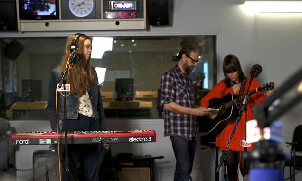 Swedish sister duo First Aid Kit keeps it all in the family with their dad as the sound guy, here he helps tune a guitar. Swedish sister duo First Aid Kit keeps it all in the family with their dad as the sound guy, here he helps tune a guitar.