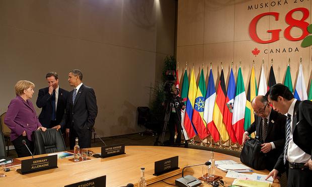 President Barack Obama talks with British Prime Minister David Cameron and German Chancellor Angela Merkel, before a meeting with African Outreach Leaders at the G8 Summit in Canada.