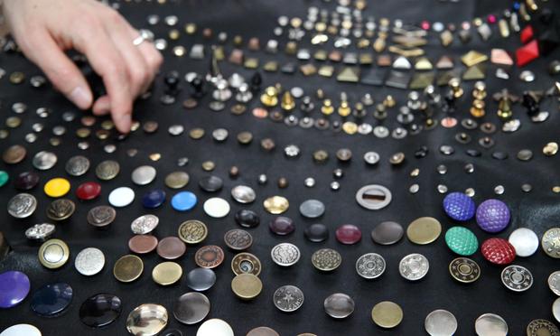 Fashion designers comb through examples of jean bottoms and rivets.
