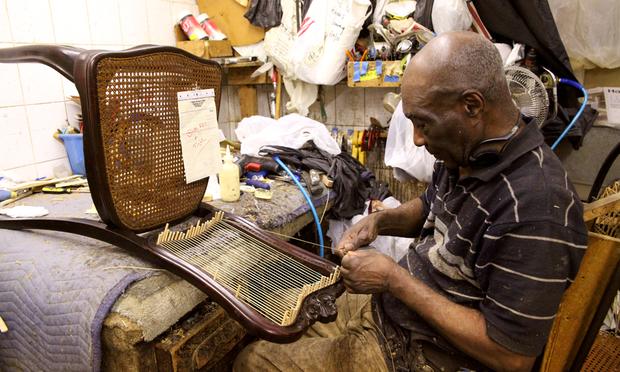 Dorvan Jordan, 77, working on chair with a French caning style.