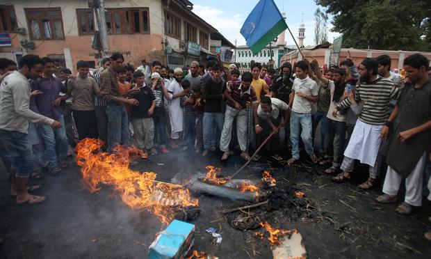 Kashmiri protesters beat the burning remains of an effigy representing US President Barack Obama during a protest in Budgam on the outskirts of Srinagar on September 13, 2010.