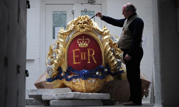 Head of Historic Carving Alan Lamb next to the royal cypher that will decorate the Royal Barge in which Britain's Queen Elizabeth II will travel on the River Thames during the diamond jubilee pageant. Head of Historic Carving Alan Lamb next to the royal cypher that will decorate the Royal Barge in which Britain's Queen Elizabeth II will travel on the River Thames during the diamond jubilee pageant.