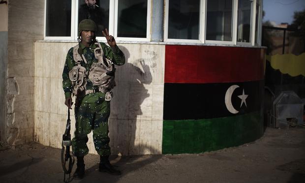 A Libyan opposition army soldier poses outside an army barrack in Benghazi on March 1, 2011. A Libyan opposition army soldier poses outside an army barrack in Benghazi on March 1, 2011.