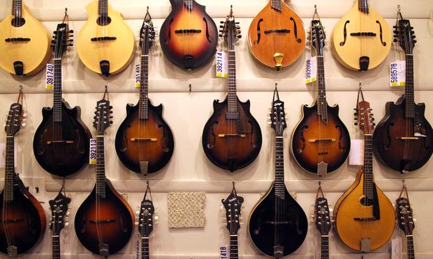 A wall of Mandolins at Mandolin Brothers. The founders chose the name because they felt the Mandolin was under-appreciated.