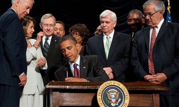 U.S. President Barack Obama signs the Dodd-Frank Wall Street Reform and Consumer Protection Act alongside members of Congress, the administration and U.S. Vice President Joe Biden US President Barack Obama signs the Dodd-Frank Wall Street Reform and Consumer Protection Act alongside members of Congress, the administration and US Vice President Joe Biden