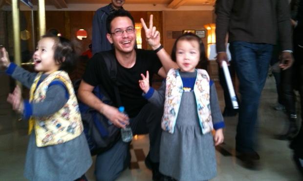 The author, posing with two girls dressed up for a wedding.