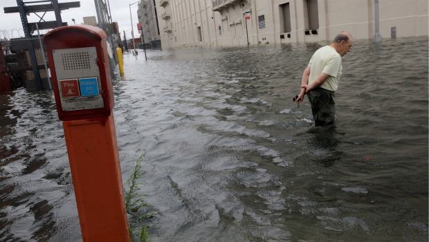 David Lutz of Red Hook wades through water over two feet deep as he enters the Brooklyn Cruise Terminal in the aftermath of Hurricane Irene on August 28, 2011 in the Brooklyn borough of New York City. David Lutz of Red Hook wades through water over two feet deep as he enters the Brooklyn Cruise Terminal in the aftermath of Hurricane Irene on August 28, 2011 in the Brooklyn borough of New York City.