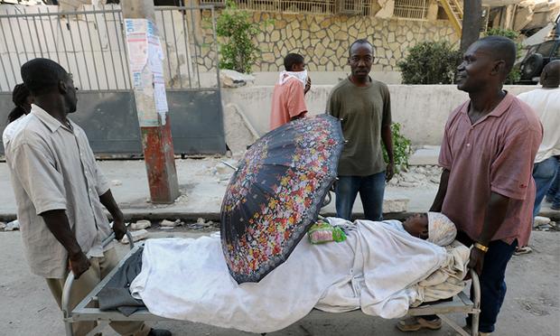 Two men carry an injured relative in Port-au-Prince, on January 14, 2010, following the devastating earthquake that rocked Haiti on January 12. Two men carry an injured relative in Port-au-Prince, on January 14, 2010, following the devastating earthquake that rocked Haiti on January 12.