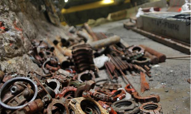 Heavy clamps for connecting pipes lay on the ground. Heavy clamps for connecting pipes lay on the ground.