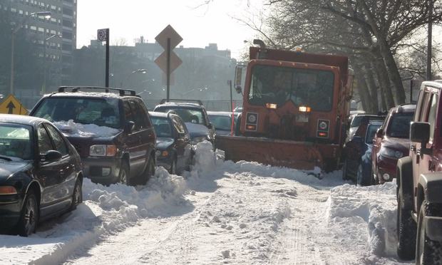 A snow plow in Brooklyn can't get passed parked cars in Brooklyn, days after the city's bungled response to the Christmas-week blizzard.