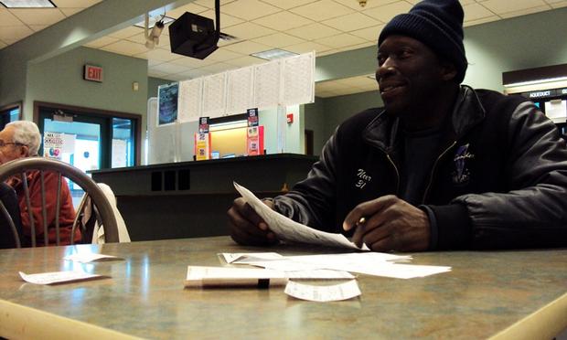 Larry Scott watches the races from the many screens at the off-track betting parlor in Phoenix, New York. He says he doesn’t have any desire to bet on the horses online and prefers the OTB.