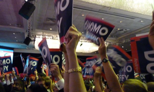 Democratic supporters are waving signs for the new governor, Andrew Cuomo