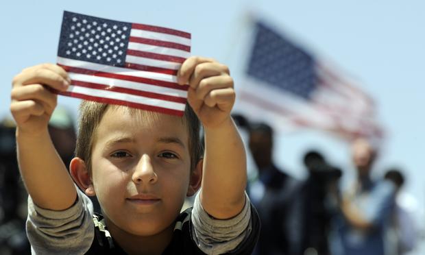A boys shows a US flag as President Barack Obama speaks on immigration at the Chamizal National Memorial on May 10, 2011 in El Paso, Texas.