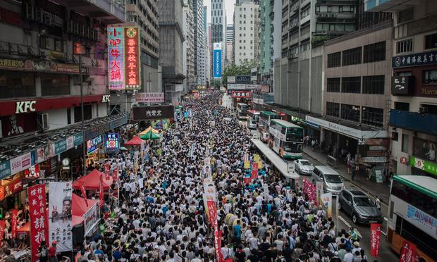 Demonstrators march during a pro-democracy rally seeking greater democracy in Hong Kong on July 1, 2014 as frustration grows over the influence of Beijing on the city.