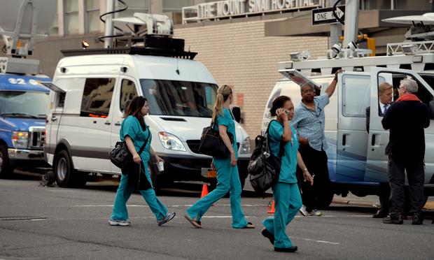 Television trucks outside Mount Sinai Hospital August 4, 2014 in New York after officials announced a male patient who recently traveled to West Africa is being tested for the ebola virus.