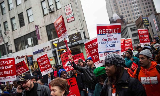 Protesters rally outside of a Wendy's in support of raising fast food wages from $7.25 per hour to $15.00 per hour on December 5, 2013 in the Brooklyn borough of New York City.