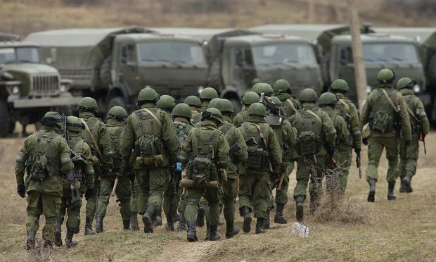 Soldiers who were among several hundred that took up positions around a Ukrainian military base walk towards their parked vehicles in Crimea on March 2, 2014 in Perevalne, Ukraine.