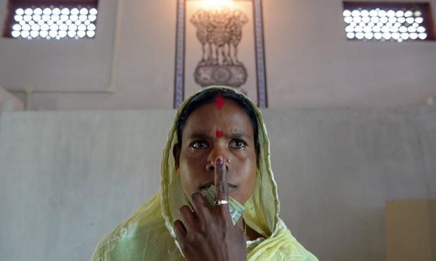 Indian resident Santoshi Bhumej, the first voter who entered the polling booth to cast her vote, poses after voting in Dibrugarh on April 7, 2014, during national elections.
