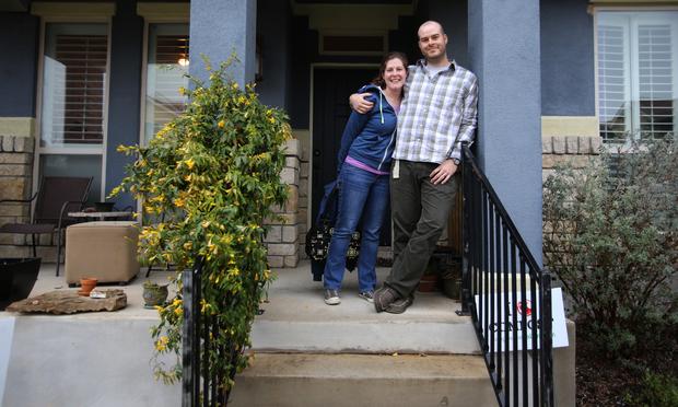 Kathy Sokolic and her husband, Mike Sears, outside their home in the Muëller community