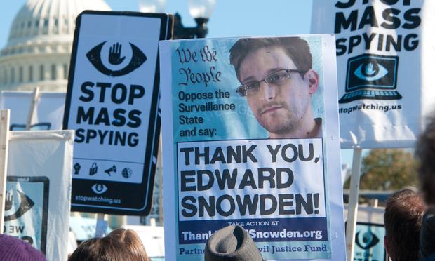 Protesters rally against mass surveillance during an event organized by the group Stop Watching Us in Washington, DC on October 26, 2013.
