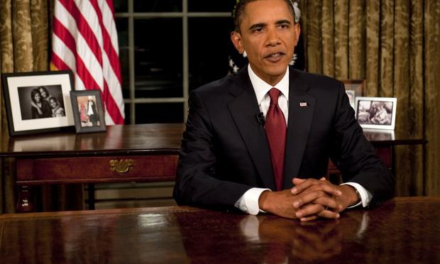 President Barack Obama reads his speech to photographers after delivering an address to the nation on the end of combat operations in Iraq from the Oval Office on August 31, 2010