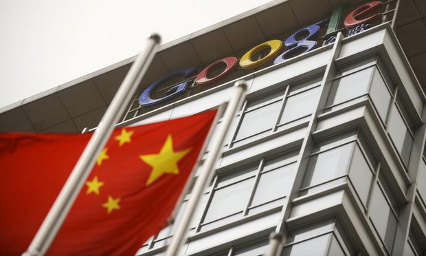 A Chinese flag flies next to the Google company logo outside the Google China headquarters in Beijing on March 22, 2010.