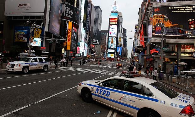 Police cruisers stand by at sunrise at the scene where a crude car bomb had been parked at 45th Street and 7th Avenue in Times Square May 2, 2010 in New York, New York.