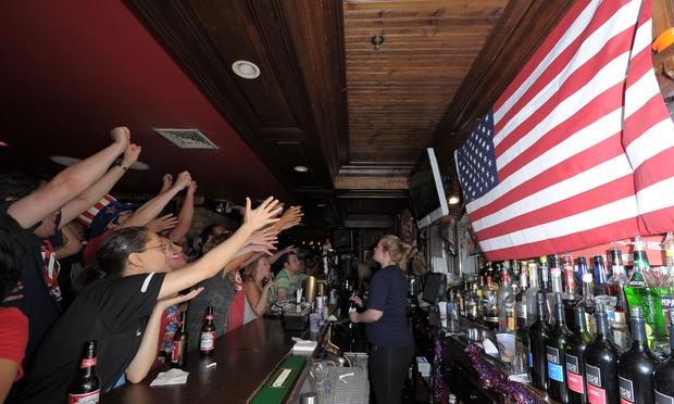 USA soccer fans react while watching the televised 2010 FIFA World Cup South Africa match between USA and Ghana at Jack Demsey's bar on June 26, 2010 in New York City.