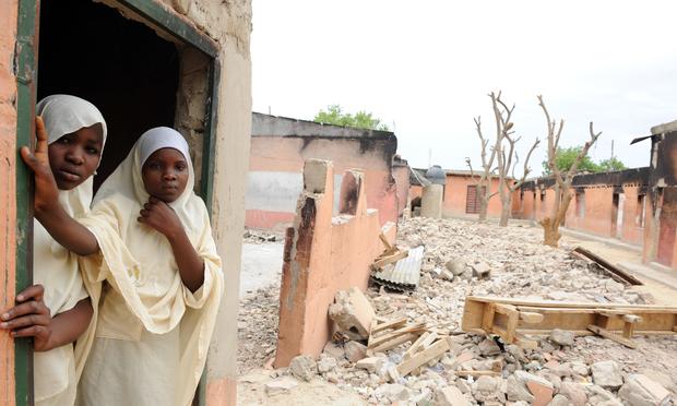 Female student stands in a burnt classroom at Maiduguri Experimental School, which was burnt by the Islamist group Boko Haram to keep children away from school. May 12, 2012