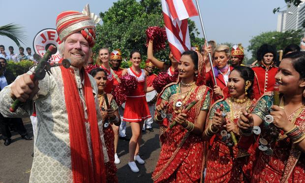 British business tycoon Richard Branson performs a traditional Lezim dance during a photo opportunity parade in Mumbai on October 26, 2012 Richard Branson performs a traditional Lezim dance during a photo opportunity parade in Mumbai on October 26, 2012