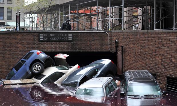Cars piled on top of each other at the entrance to a garage on South Willliam Street in Lower Manhattan October 31, 2012 in New York as the city begins to clean up after Hurricane Sandy. Cars piled on top of each other at the entrance to a garage on South Willliam Street in Lower Manhattan October 31, 2012 in New York as the city begins to clean up after Hurricane Sandy.