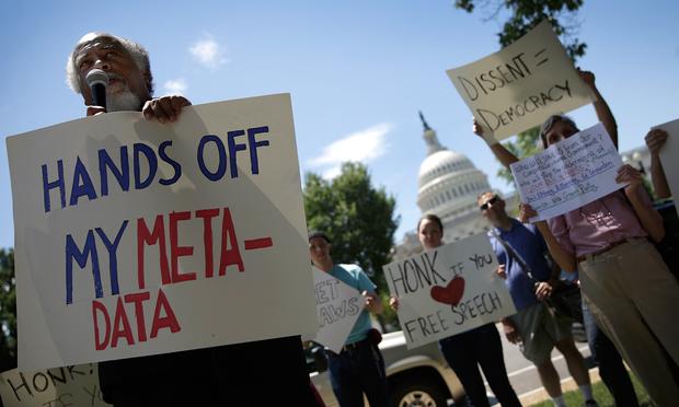 Kwazi Nkrumah speaks while joining protesters rallying outside the U.S. Capitol against the NSA's recently detailed surveillance programs June 13, 2013 in Washington, DC.