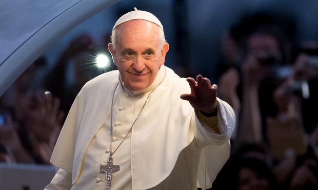 Pope Francis waves from the Popemobile on his way to attend the Via Crucis on Copacabana Beach during World Youth Day celebrations on July 26, 2013 in Rio de Janeiro, Brazil.