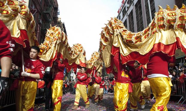 Pupeteers carry two traditional Chinese dragons at the Lunar New Year parade in Chinatown, NY. Pupeteers carry two traditional Chinese dragons at the Lunar New Year parade in Chinatown, NY.