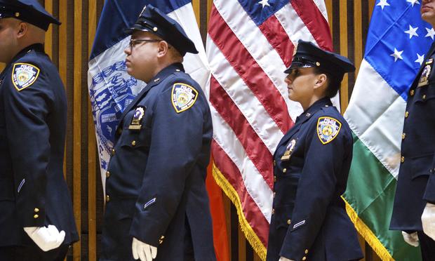 NYPD officers wait in line during a ceremony at One Police Plaza. NYPD officers wait in line during a ceremony at One Police Plaza.
