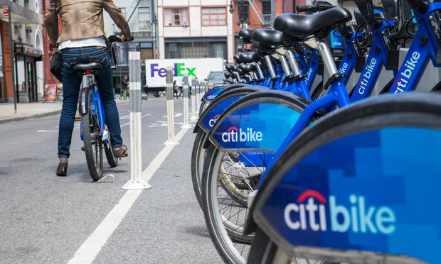 A woman checks a bike out from a Citi Bikes station in lower Manhattan. A woman checks a bike out from a Citi Bikes station in lower Manhattan.