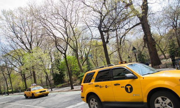 Taxis pass Washington Square Park on a sunny day in late April. Taxis pass Washington Square Park on a sunny day in late April.