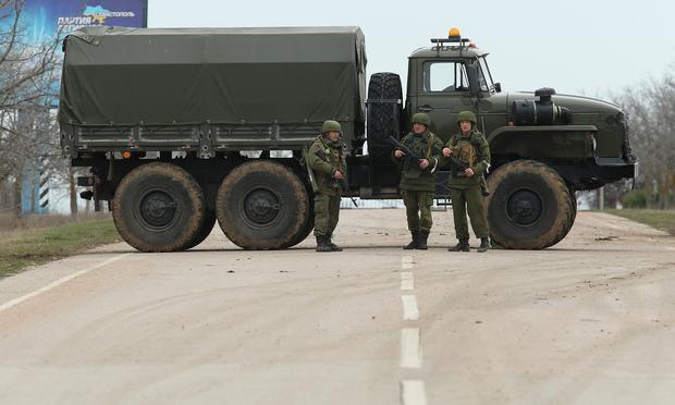 A truck and soldiers block the road leading to Babek Airport near Sevastopol that is occupied by Russian troops in Crimea on March 2, 2014 near Balbek, Ukraine.