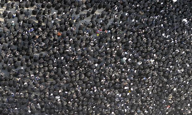 Thousands of Orthodox Jews gather in lower Manhattan March 9, 2014 to pray and protest against the effort by the Israeli government to pass a law to draft religious Jews.