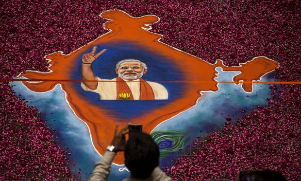 A supporter takes a picture of a map of India made of flowers with a picture of BJP leader Narendra Modi on it at the party's headquarters on May 16, 2014 in Ahmedabad, India. A supporter takes a picture of a map of India made of flowers with a picture of BJP leader Narendra Modi on it at the party's headquarters on May 16, 2014 in Ahmedabad, India.