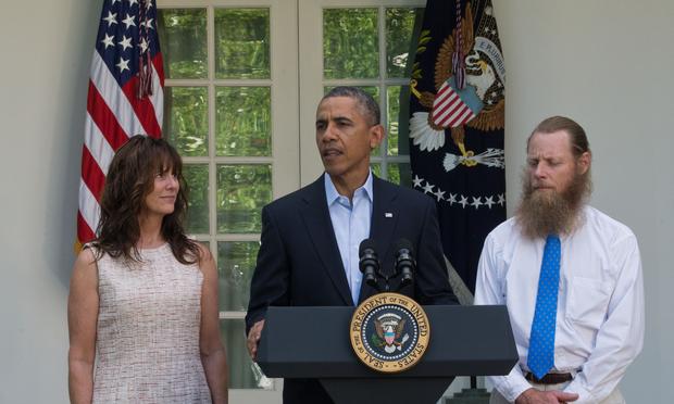 President Barack Obama makes a statement about the release of Sgt. Bowe Bergdahl as his parents, Jani Bergdahl (L) and Bob Bergdahl (R) listen May 31, 2014 in the Rose Garden at the White House.