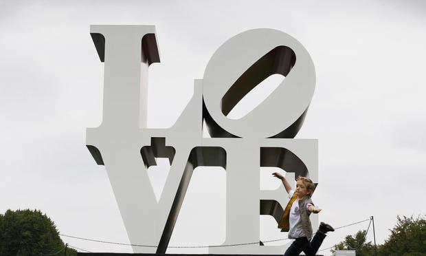 A young boy plays in front of sculpture entitled 'The American Love' by Robert Indiana in the gardens of Chatsworth House near Bakewell, Derbyshire on September 14, 2008.