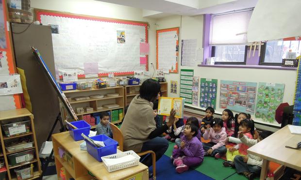 A teacher reads to a pre-kindergarten class at Bright Beginnings Child Care in Jamaica, Queens. The organization submitted a proposal to convert its half-day classes to full-day.