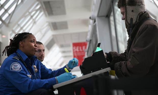 A TSA agent checks a traveler's identification at a special TSA Pre-check lane at Terminal C of the LaGuardia Airport on January 27, 2014 in New York City. A TSA agent checks a traveler's identification at a special TSA Pre-check lane at Terminal C of the LaGuardia Airport on January 27, 2014 in New York City.