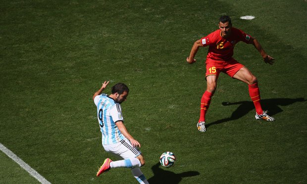 Gonzalo Higuain of Argentina scores against Daniel Van Buyten of Belgium during the 2014 FIFA World Cup Brazil Quarter Final match between at Estadio Nacional on July 5, 2014 in Brasilia, Brazil. Gonzalo Higuain of Argentina scores against Daniel Van Buyten of Belgium during the 2014 FIFA World Cup Brazil Quarter Final match between at Estadio Nacional on July 5, 2014 in Brasilia, Brazil.