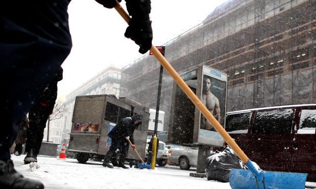 Shoveling snow on the second big snow fall of the year in Midtown, on January 21, 2014. Shoveling snow on the second big snow fall of the year in Midtown, on January 21, 2014.