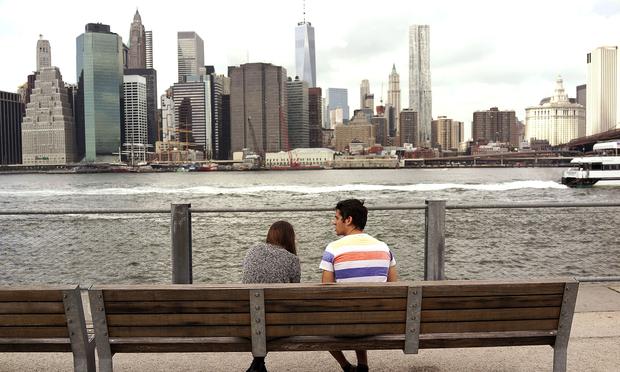 People relax at a waterfront in Brooklyn.