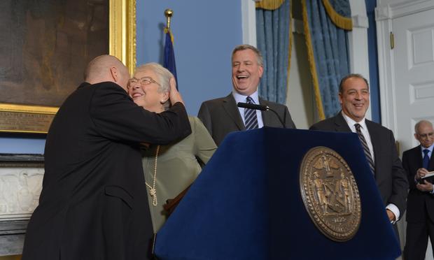 UFT president Michael Mulgrew and Schools Chancellor Carmen Fariña embrace at a press conference announcing a contract for New York City teachers.