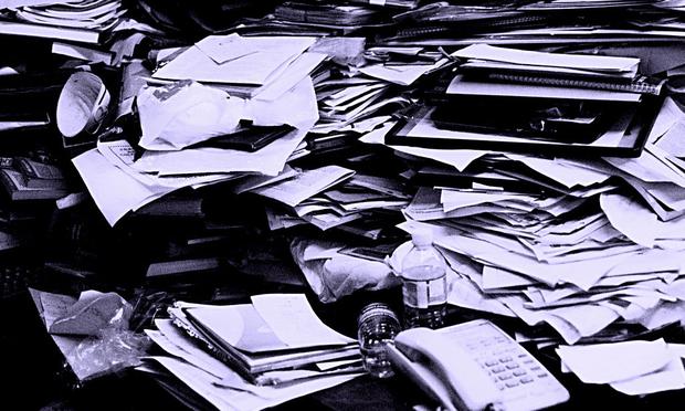 Some people have a difficult time throwing things away, even when clutter gets in the way. cluttered desk